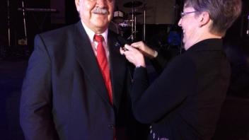 Dr. Bradley pinning the WPSA symbol on Dr. Sergio Salazar (founding Branch President) at the inauguration of the new WPSA Branch in Bolivia